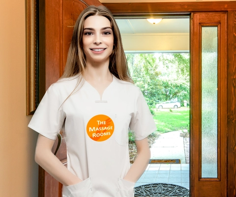 A Massage Rooms therapist in uniform arriving at a client's front door for a home visit.
